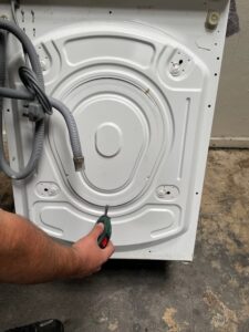 removing screws holding rear cover on a bosch washing machine